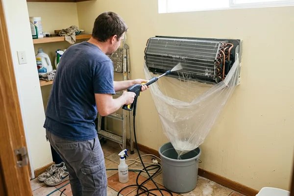 Bare evaporator coil being rinsed after the parts are removed