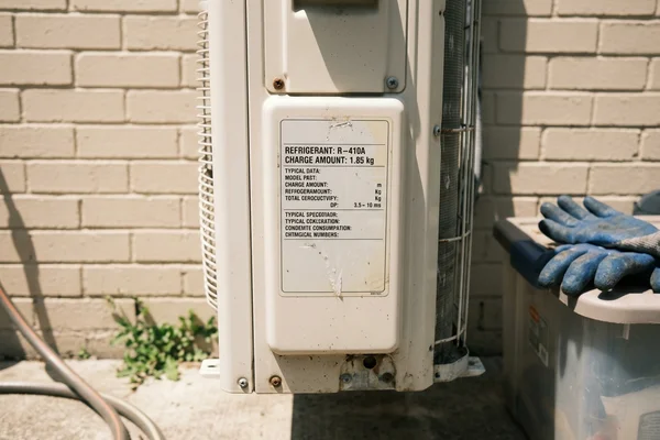 Outdoor unit rating plate showing the refrigerant type