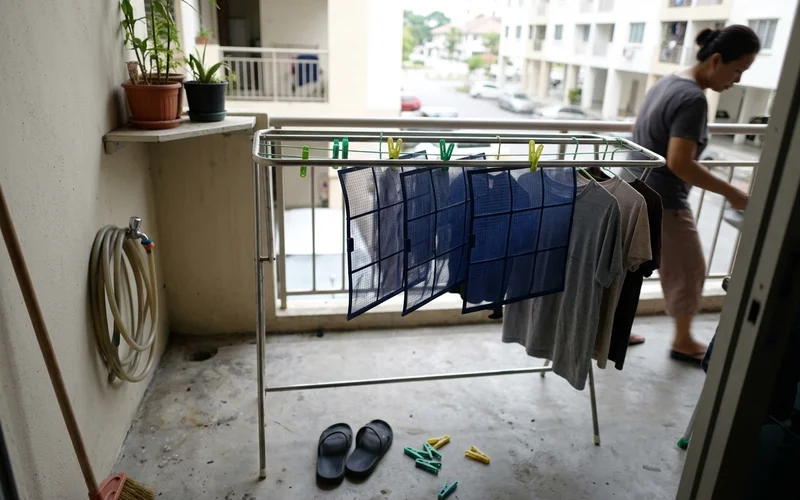 Rinsed aircon filters drying in the shade on a balcony