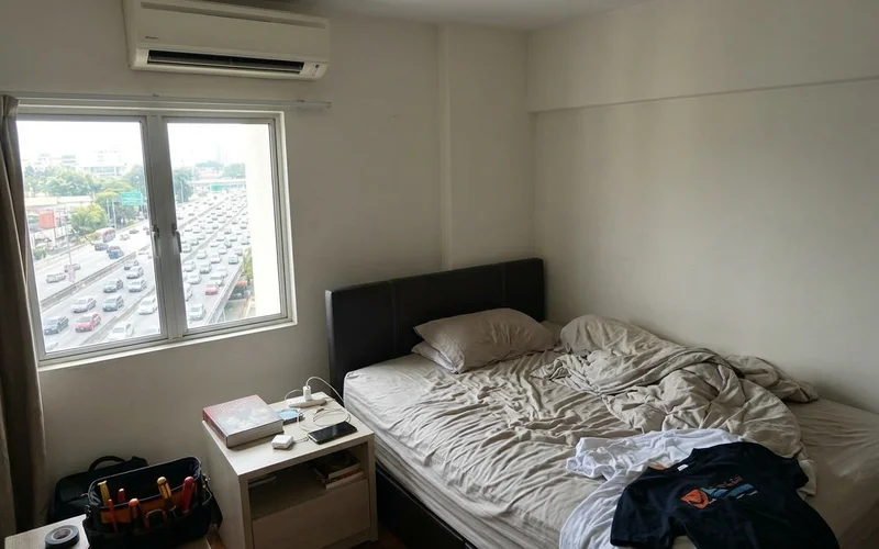 Condo bedroom aircon with a busy road visible through the window