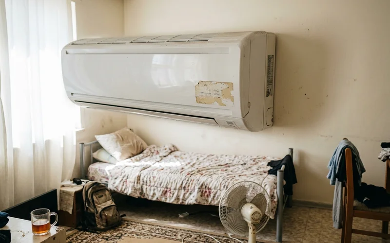 A dusty, neglected indoor unit in a rental room