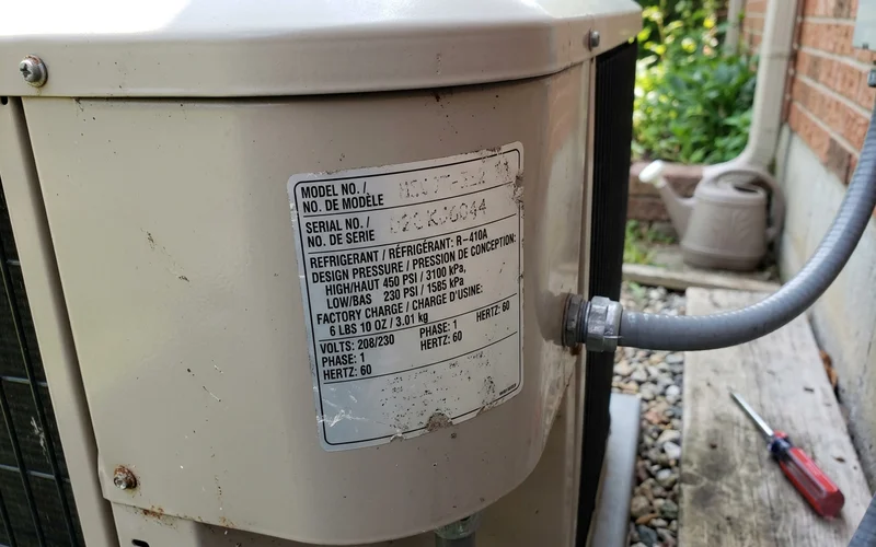 Rating plate on an outdoor unit showing the refrigerant type
