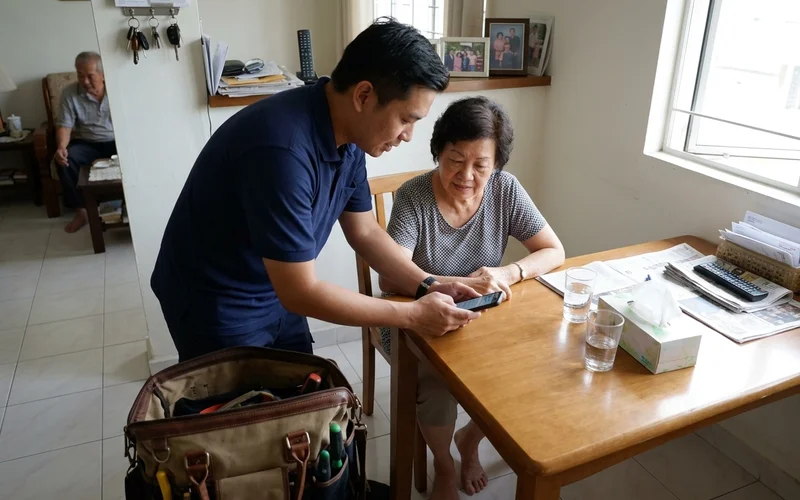 Technician explaining a repair quote to a homeowner at the dining table