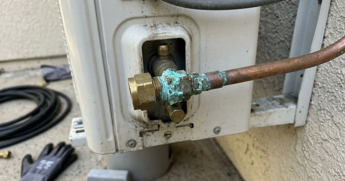 Greenish corrosion on a copper flare joint at the outdoor unit